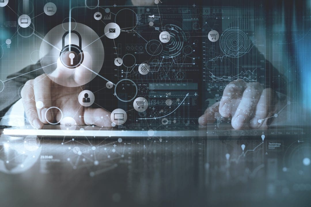 Person typing on keyboard and using touchscreen with security icons